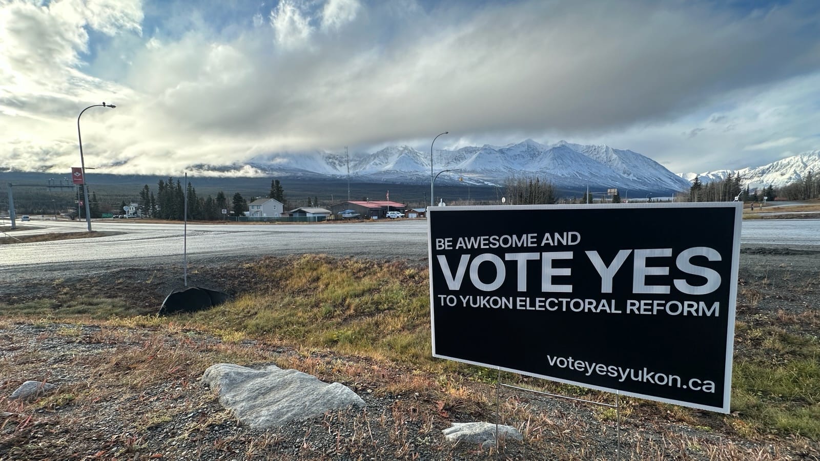 A “Vote YES Yukon” lawn sign in Haines Junction, with the Saint Elias mountain range in the background.